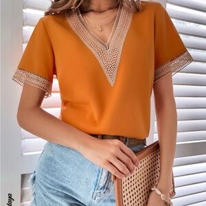 Cute orange shirt that would look great in the summer! Cute details to it!